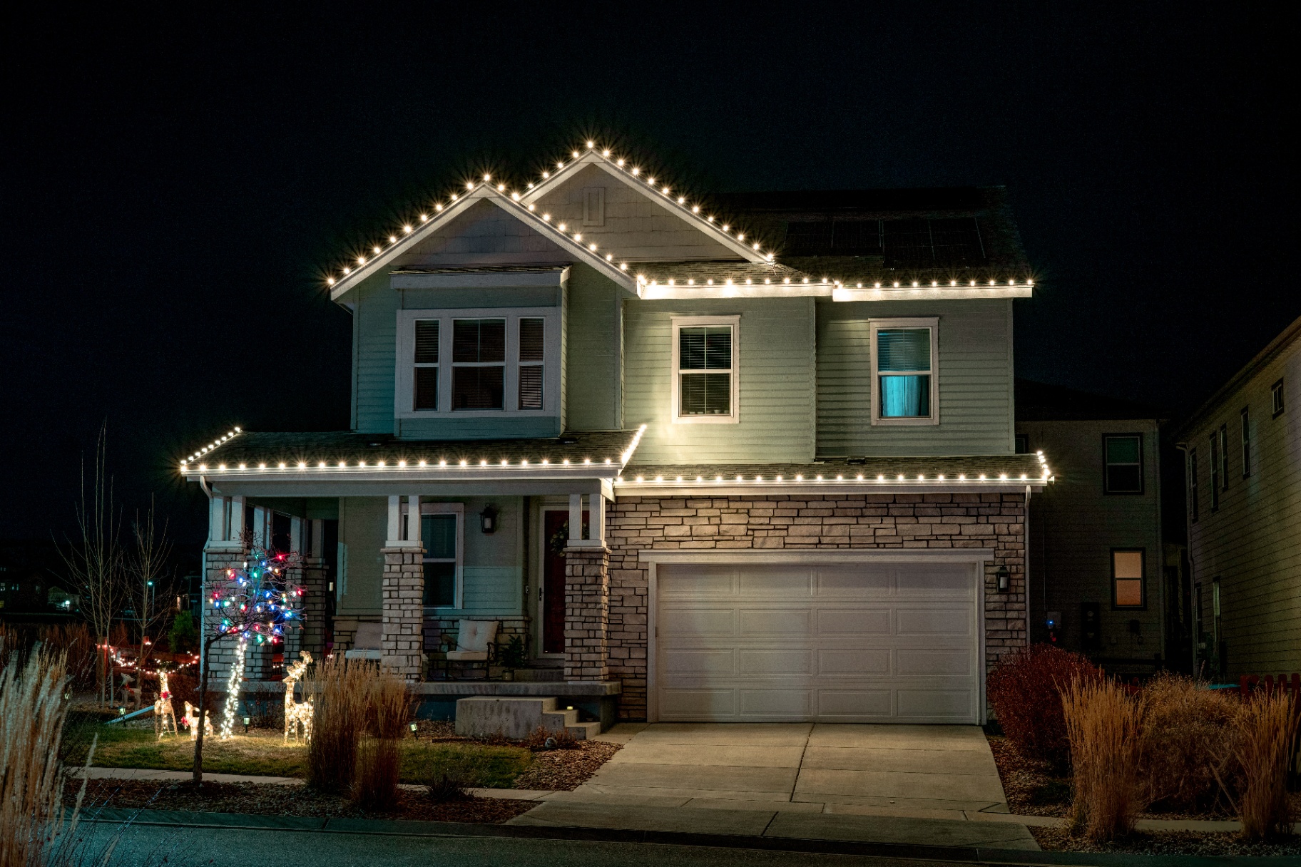 Warm white C9 Christmas lights on a two-story home